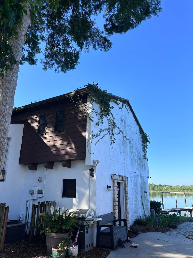 Before photo of weathered home exterior prior to painting and restoration