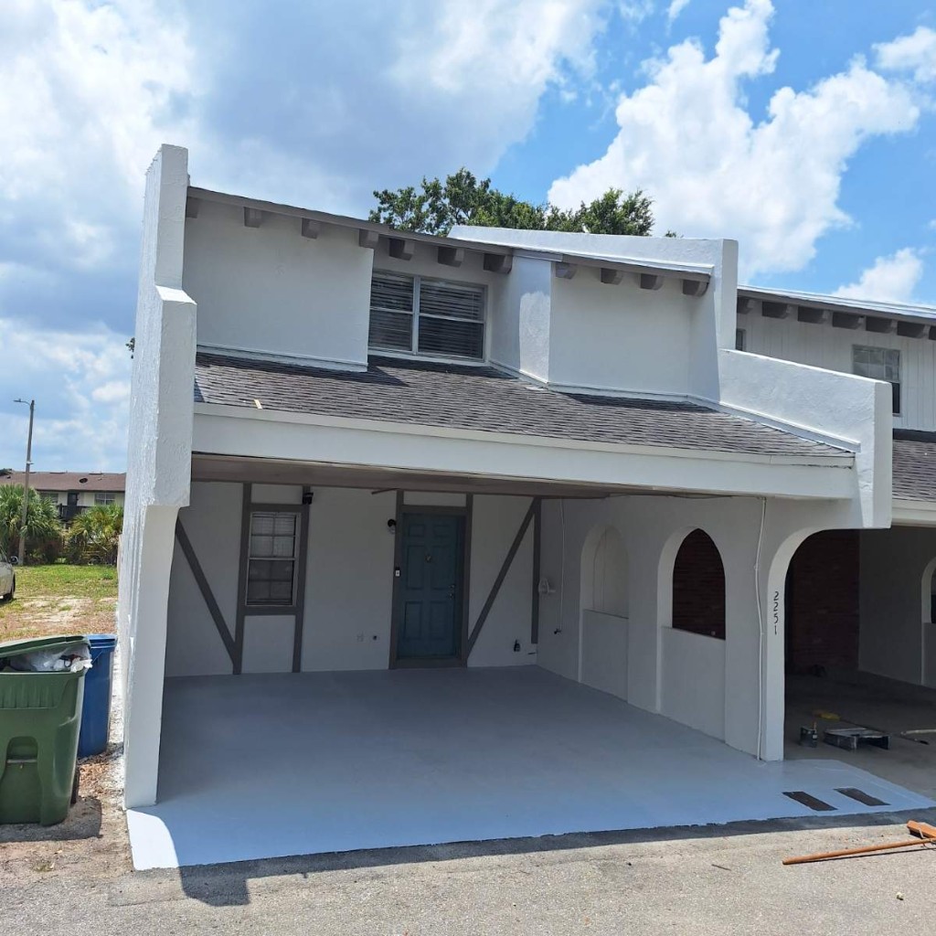 Restored and freshly painted residential exterior after Trinrez renovation and coating work